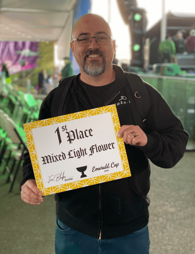 Josh D holding 1st Place award at Emerald Cup